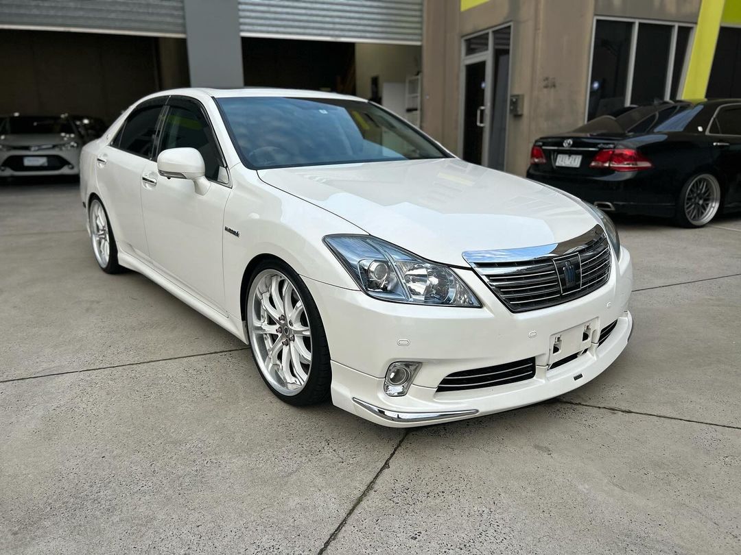 A white Toyota Avalon parked in front of a building.