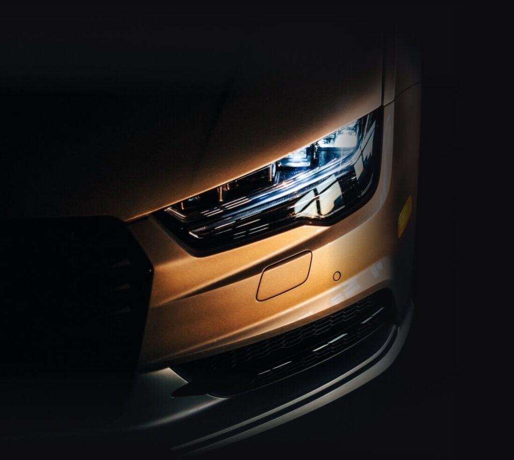 A close-up of the sleek and modern headlight of a nissan car, showcasing its elegant design and powerful illumination.